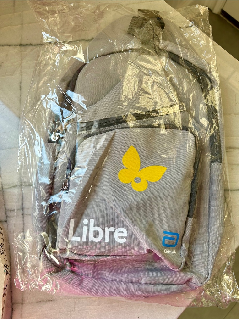 Sling backpack- gray, sponsored by Libre from Abbott.